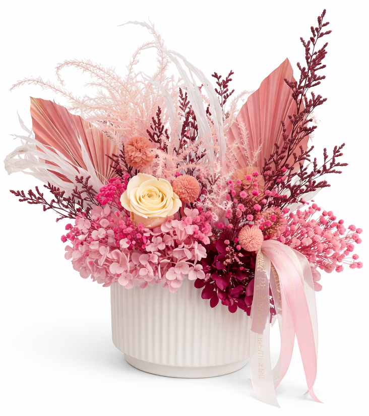 A medium floral arrangements with pink and white flowers in white ceramic vase